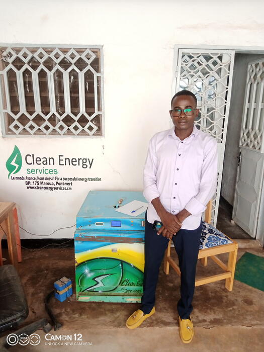 Entrepreneur Triomphant presents one of his solar powered fridges 