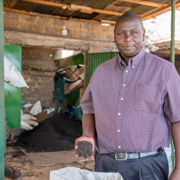 Owner of Organic Fields Ltd presents a handful of his organic fertilizer. #GreenCallKenya