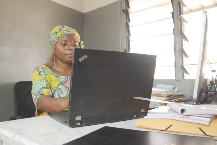 WIDU entrepreneur in colourful dress works on her computer