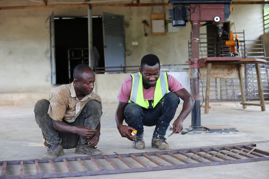 Stephen Orlando Mensah with his employee in their workshop in Ghana. 