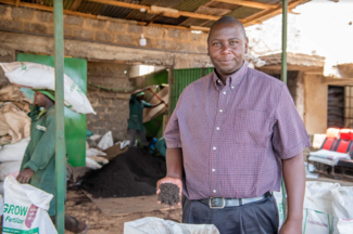 Owner of WIDU supported business Organic Fields Ltd presents a handful of his organic fertilizer. #GreenCallKenya