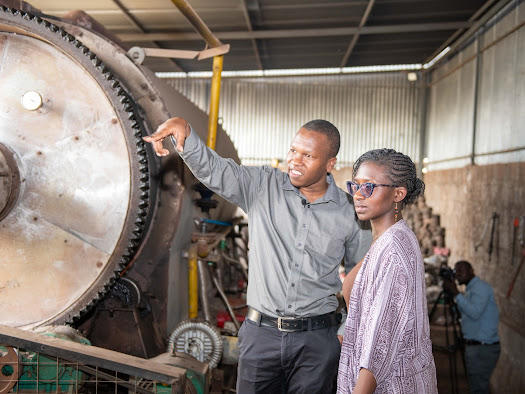 Entrepreneur checks industrial plant and shows it to young woman