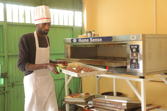 Beta Blocker Initiative employee in front of oven